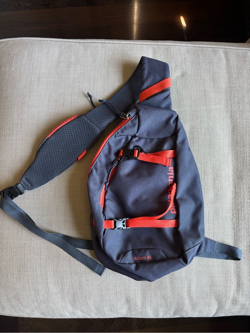 Patagonia Atom 8L Crossbody Sling Pack in Dark Grey with Red/Orange Details
